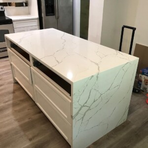 Kitchen island with a white veined waterfall countertop