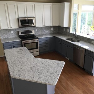 Kitchen with an angled gray speckled countertop island