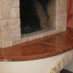 Fireplace hearth with a curved red marble-look top